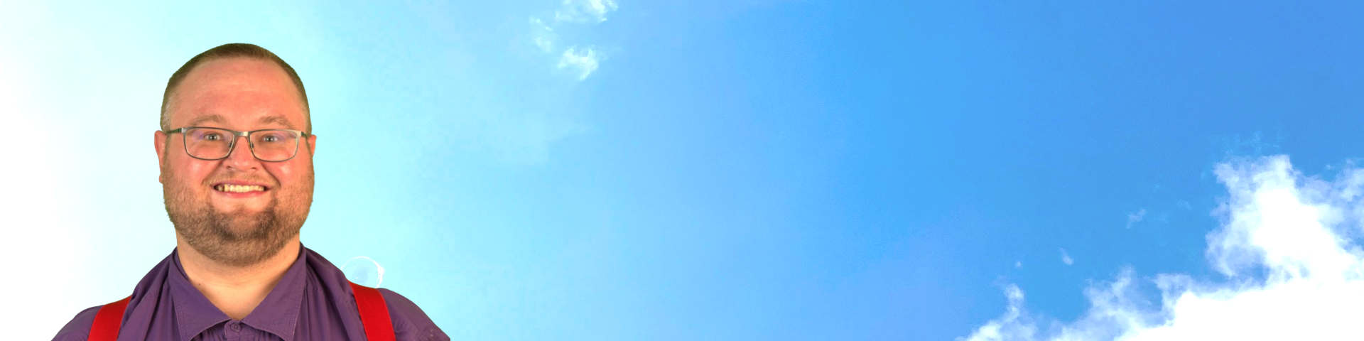 Headshot of Don with a cloudy blue sky background 1920x480a